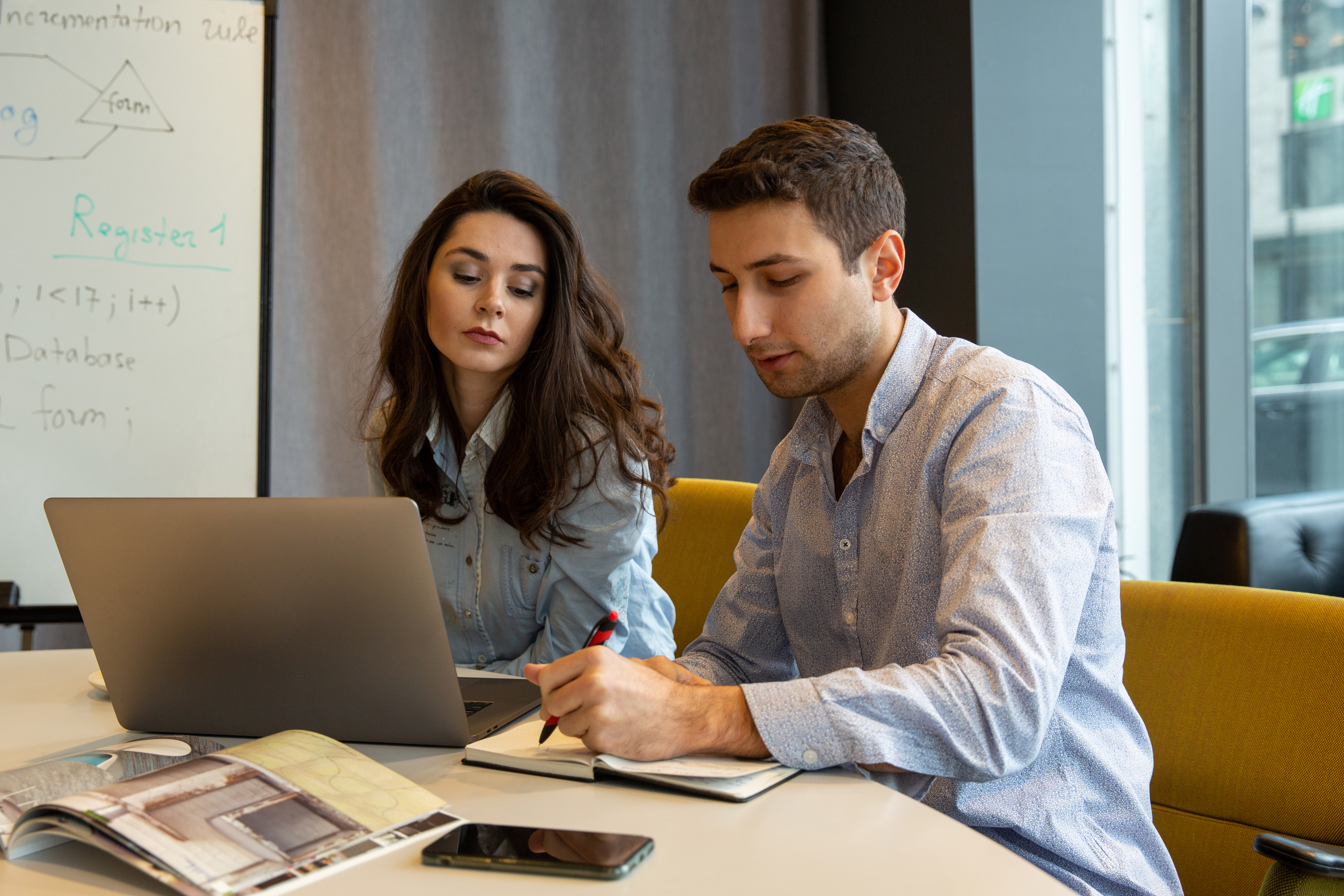 Two professionals working together on laptop